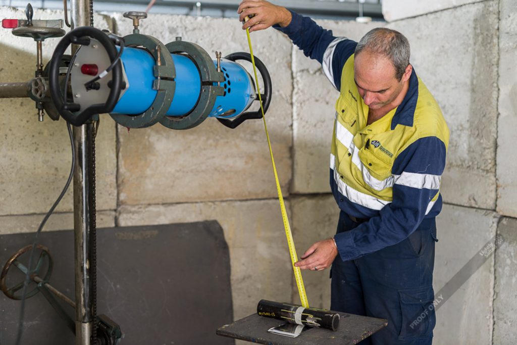 Intertek technician preparing to examine a welded component for asset management testing using an Yxlon Y.XPO tube head.