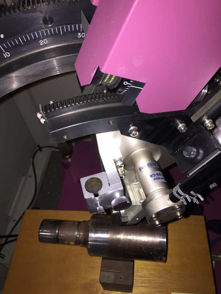 Steel roller mounted in preparation for residual stress analysis in a Rigaku PSPC/MSF rapid stress analyser.